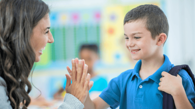 Educator high-fiving a student receiving Medicaid-eligible school services